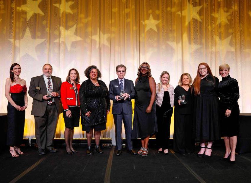 Gretchen Wood, Nina Nasca, Mariellen Nasca, Gianna Nasca, DeAnna Burt-Nanna, Tom Battley, Daniele Lyman-Torres '02, Maureen Wolfe, Jim Sydor '71 and Alexis Vogt on Salute to Excellence stage